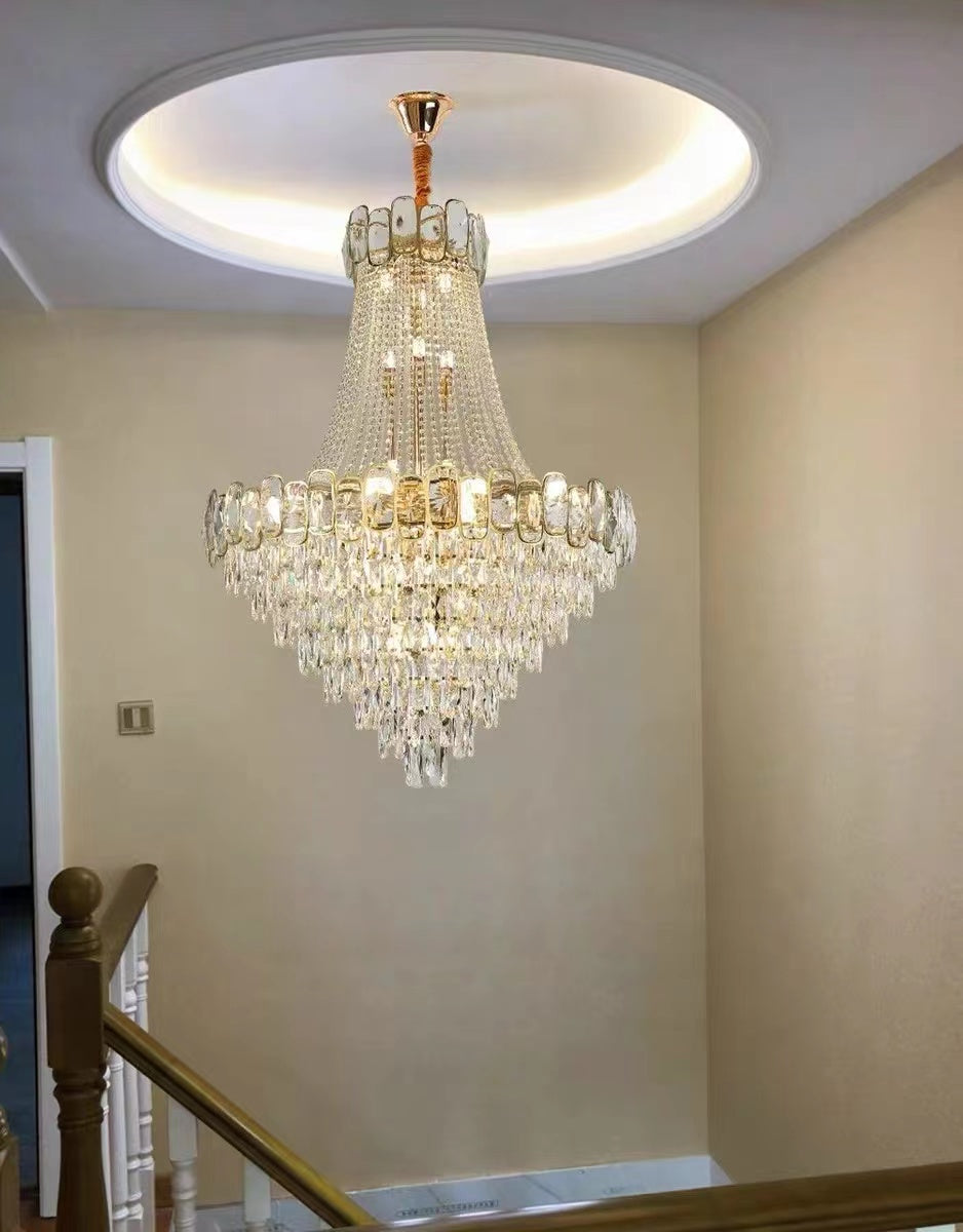 https://cdn.shopify.com/s/files/1/0736/8795/7790/files/foyer-staircase-chandelier-luxury-k9-crystal-ceiling-light-for-living-room-hallway-merlin-lamps-6.jpg?v=1765361007