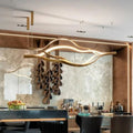 https://cdn.shopify.com/s/files/1/0736/8795/7790/files/modern-simple-brass-waving-chandelier-for-livingdining-roomkitchen-island-merlin-lamps-2.jpg?v=1767690874