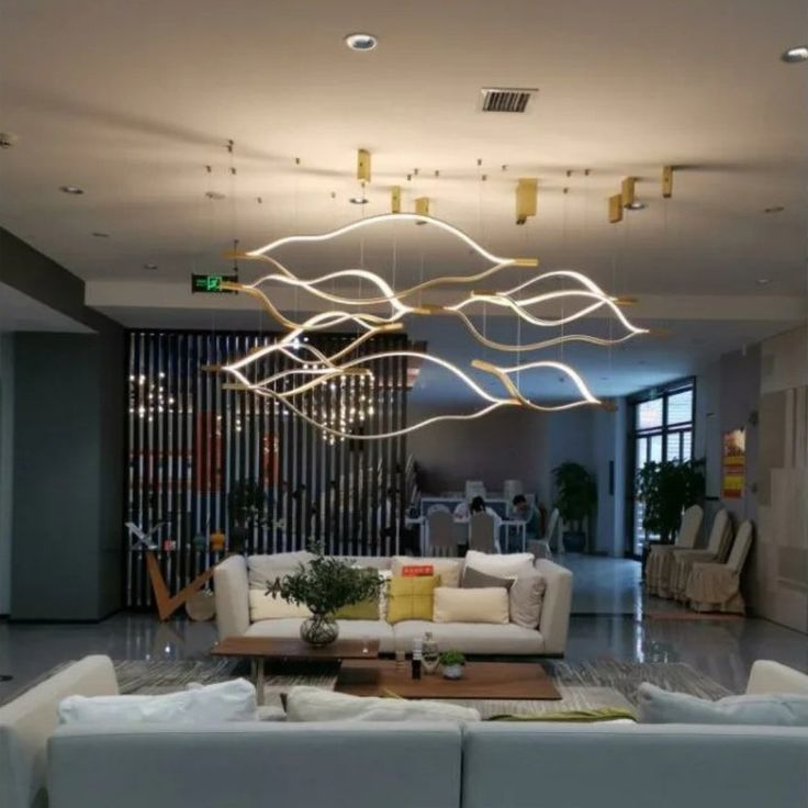 https://cdn.shopify.com/s/files/1/0736/8795/7790/files/modern-simple-brass-waving-chandelier-for-livingdining-roomkitchen-island-merlin-lamps.jpg?v=1767690874